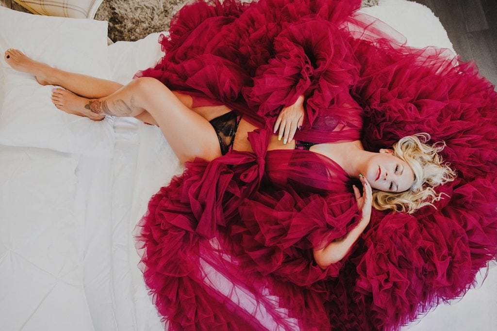 woman wearing a luxurious burgundy boudoir robe