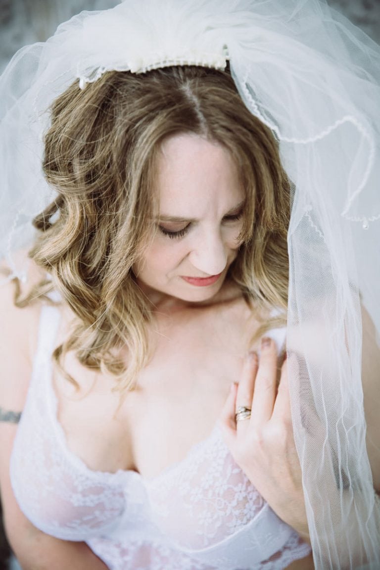 bride wearing wedding lingerie and a veil