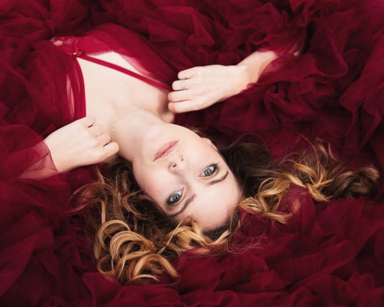 woman laying down wearing a red robe