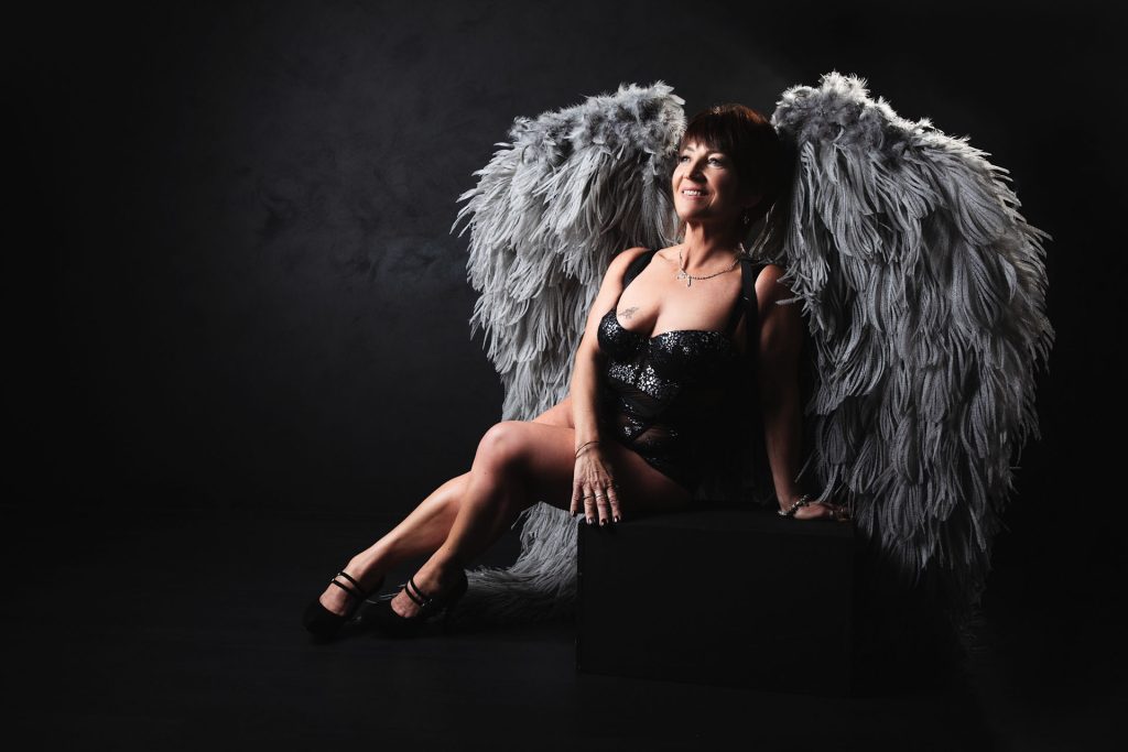 seated angel wings boudoir pose