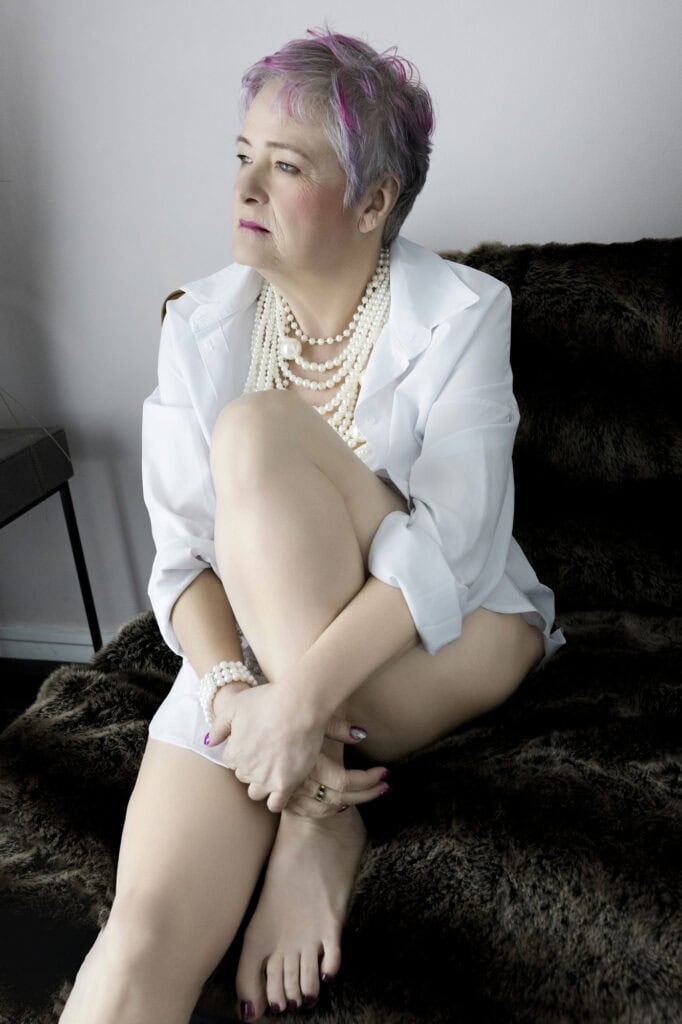woman sitting wearing a oversized white shirt